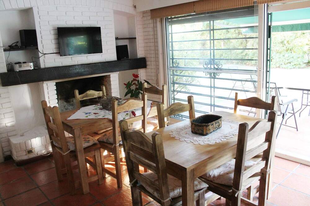 Comedor con estufa y ventanales al jardín